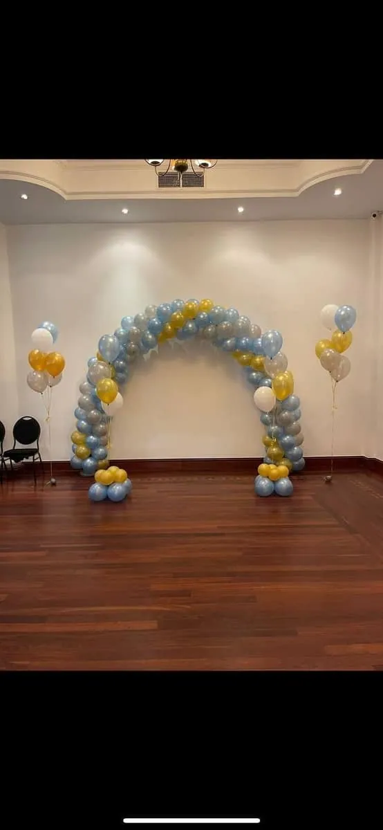 Gold and silver balloon arch at a doorway