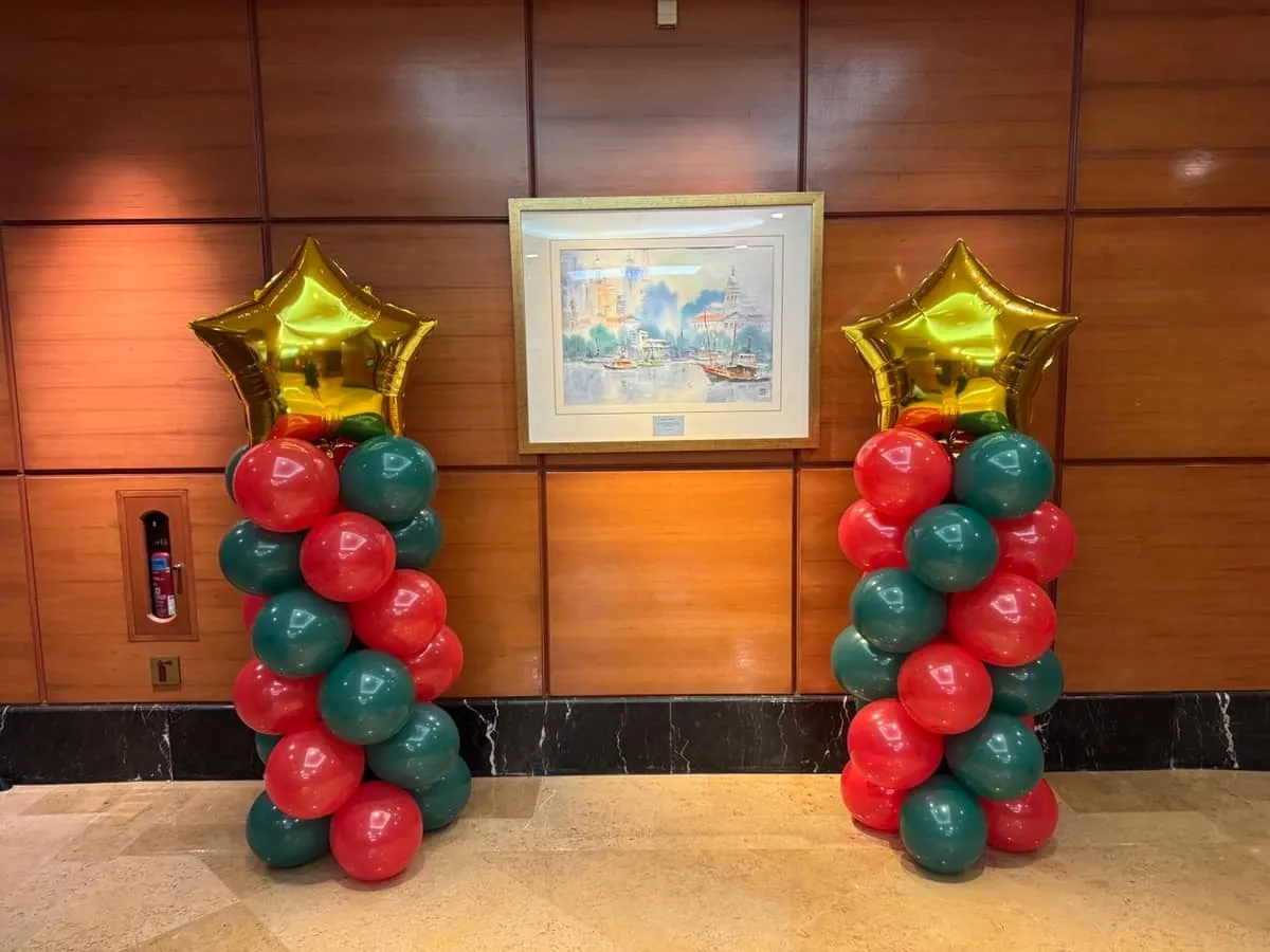 Red and green Christmas themed balloon columns