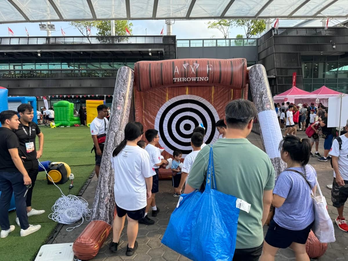 Guests queuing for a wood target throwing game