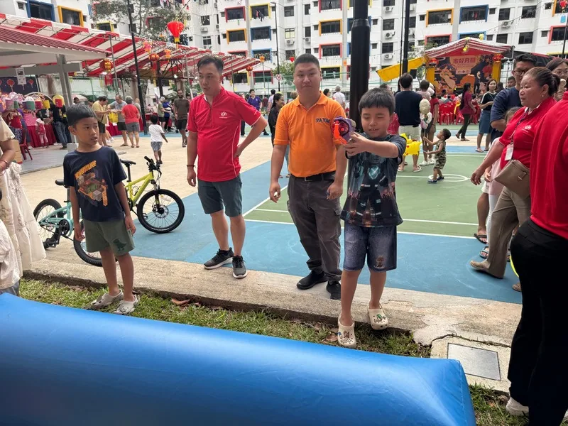 Families playing inflatable games on a court