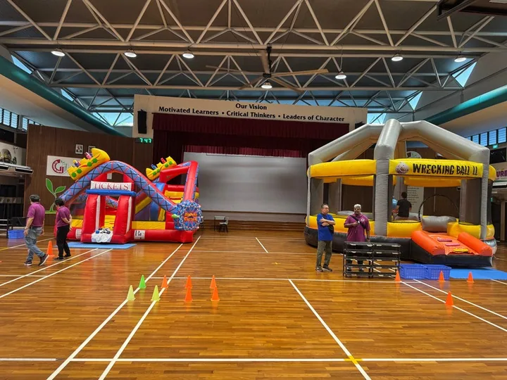 Bouncy castles set up across a school hall